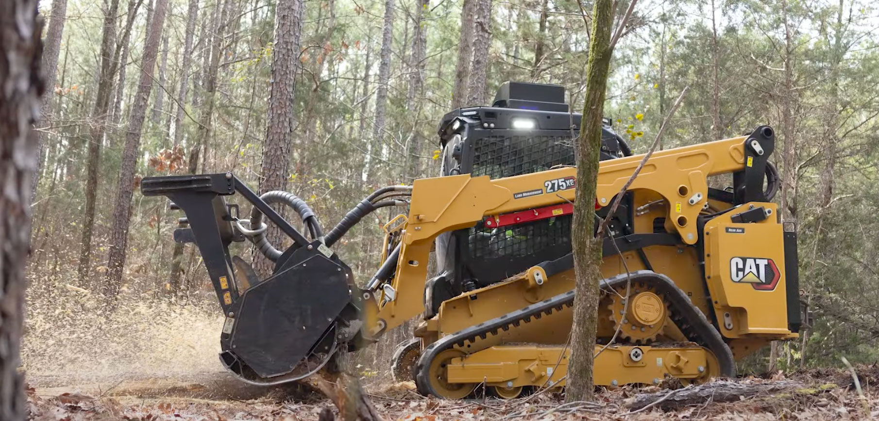 Forestry mulching equipment working through brush and wooded overgrowth, showing property cleanup support for Liberty and Kansas City area land management projects.